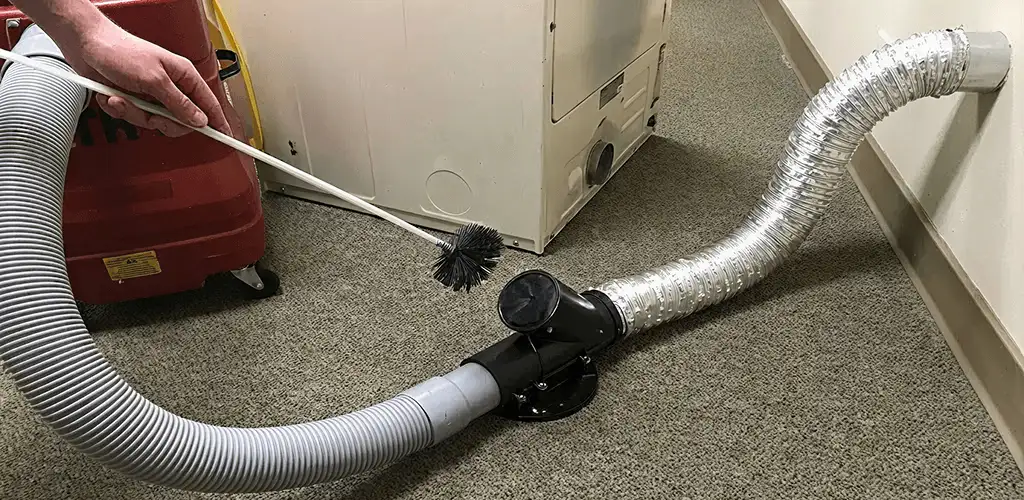 Dryer vent cleaning service removing lint from a dryer duct connection in Little Rock, AR