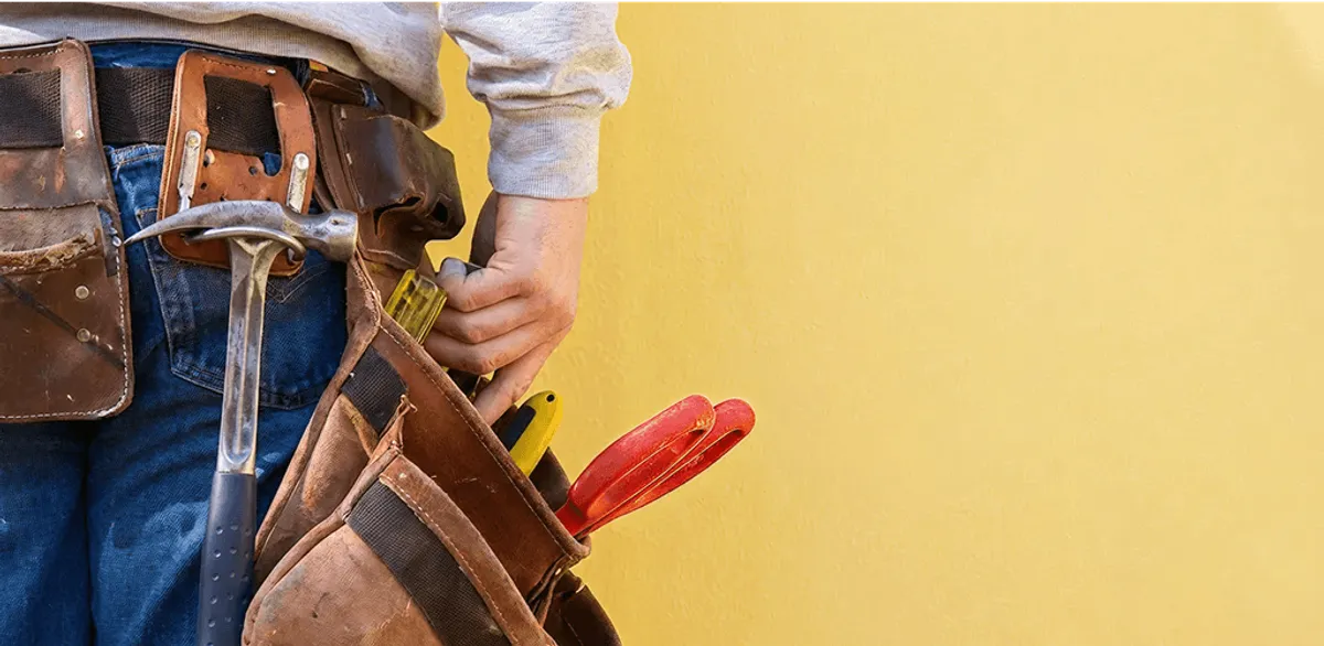 Handyman with tool belt ready for home repairs and maintenance in Little Rock, AR