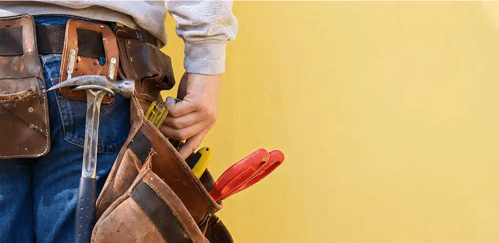 Handyman with tool belt ready for home repairs and maintenance in Little Rock, AR