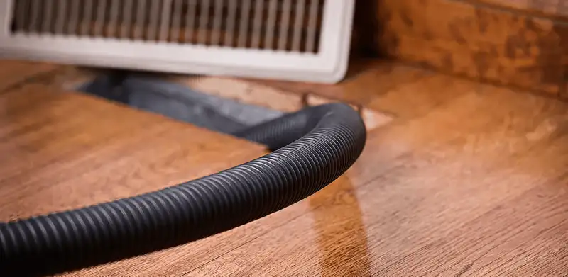 Air duct cleaning hose inserted into a floor vent for ductwork cleaning in Little Rock, AR